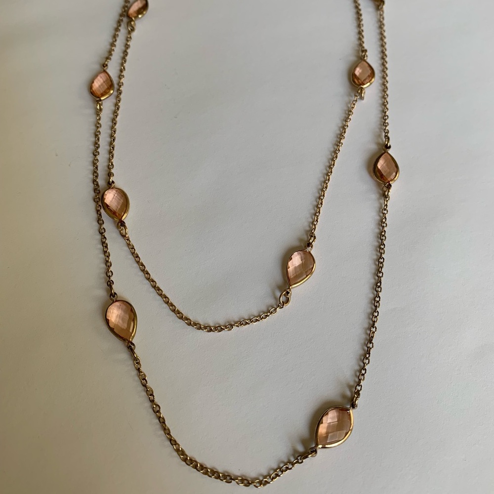 Long gold necklace with pale pink jewels